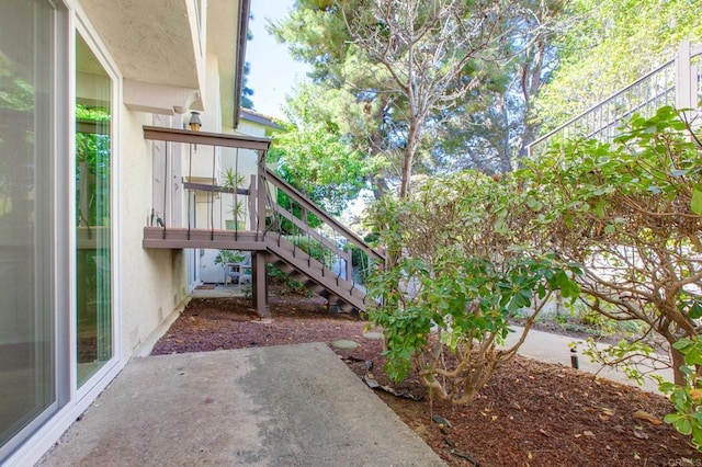 view of yard featuring a patio and stairway