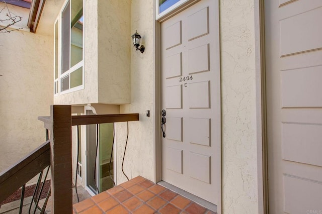 doorway to property with stucco siding