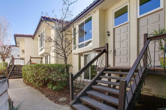property entrance with stucco siding