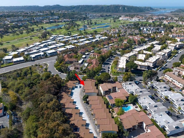 aerial view featuring a water view, view of golf course, and a residential view