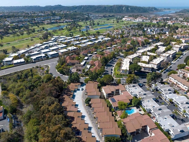 birds eye view of property with a water view, view of golf course, and a residential view