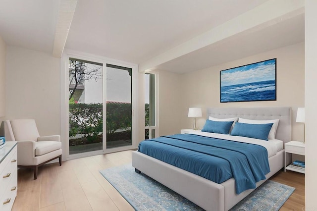 bedroom with access to outside and light wood-type flooring