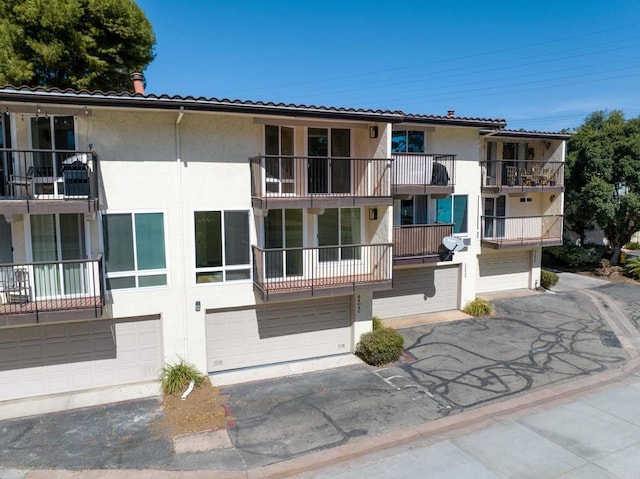 view of building exterior featuring driveway and a garage