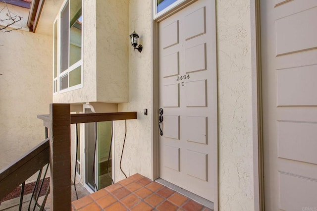 property entrance with stucco siding
