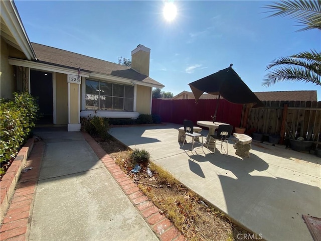 view of patio featuring fence