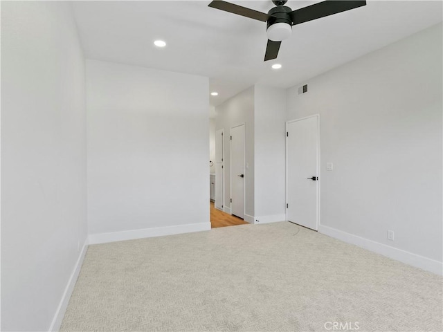 interior space featuring recessed lighting, baseboards, light carpet, and ceiling fan