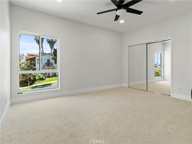 unfurnished bedroom featuring recessed lighting, a closet, carpet floors, and baseboards