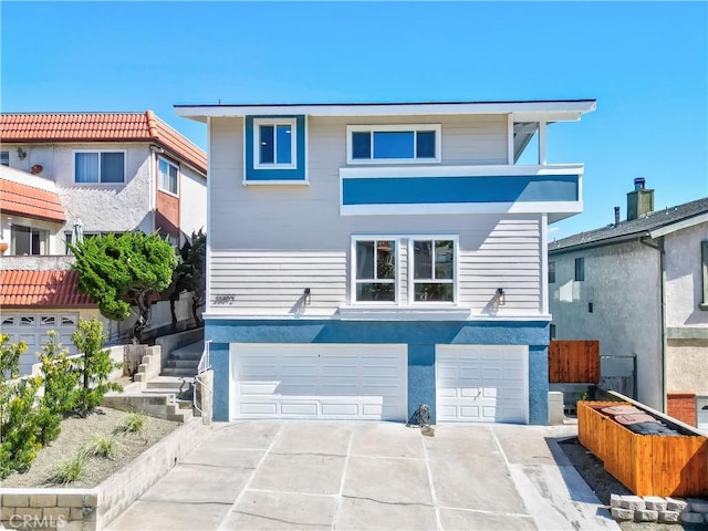 view of front of property with stucco siding, driveway, and an attached garage