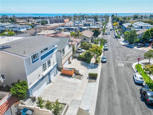 drone / aerial view with a residential view and a water view