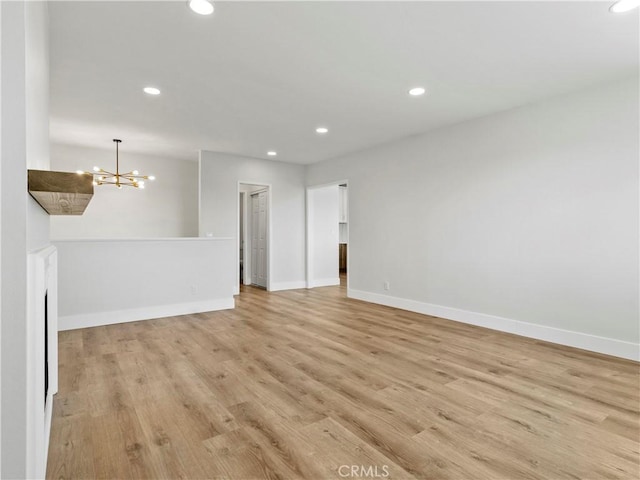 empty room with recessed lighting, baseboards, and light wood finished floors