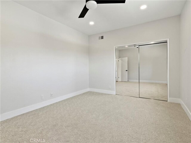 unfurnished bedroom with baseboards, recessed lighting, ceiling fan, a closet, and carpet flooring