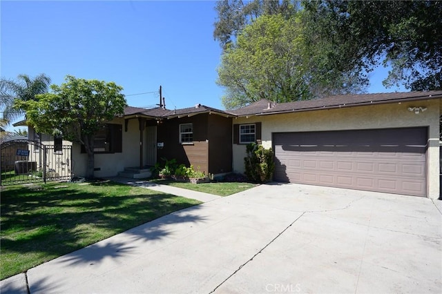 ranch-style home featuring a garage, driveway, a front lawn, and stucco siding