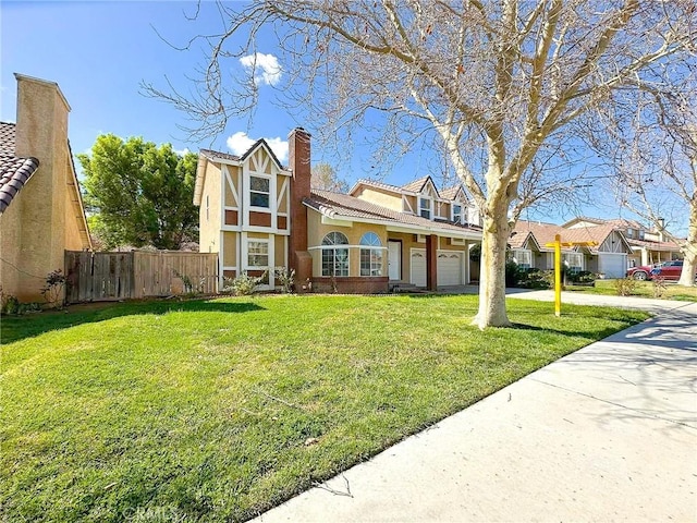 view of front of property featuring concrete driveway, fence, a front lawn, and an attached garage