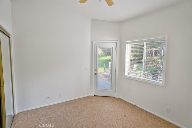 unfurnished room with light carpet, ceiling fan, and baseboards