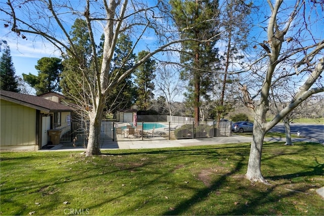 view of yard with fence and a fenced in pool