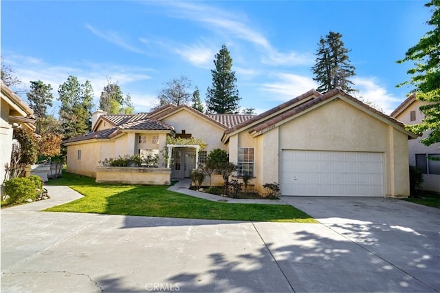 mediterranean / spanish home featuring a garage, concrete driveway, stucco siding, a tiled roof, and a front yard