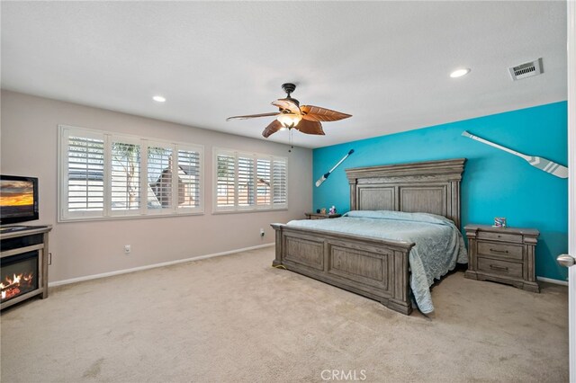 bedroom featuring a ceiling fan, carpet, visible vents, and baseboards