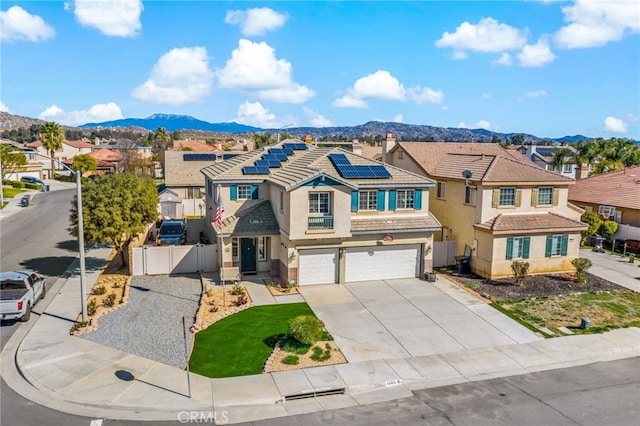 traditional-style home featuring a residential view, a gate, fence, and a mountain view