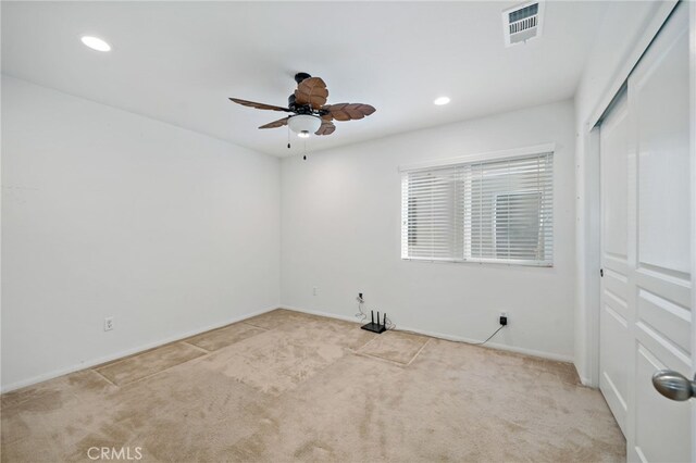 carpeted spare room featuring ceiling fan, visible vents, baseboards, and recessed lighting