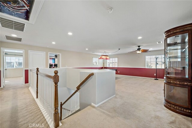 hall featuring recessed lighting, visible vents, light carpet, and an upstairs landing