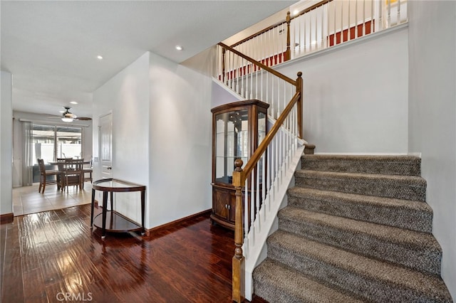 stairs with ceiling fan, recessed lighting, hardwood / wood-style flooring, and baseboards