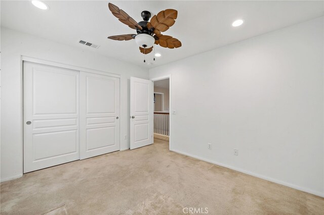 unfurnished bedroom with recessed lighting, a closet, visible vents, carpet flooring, and baseboards