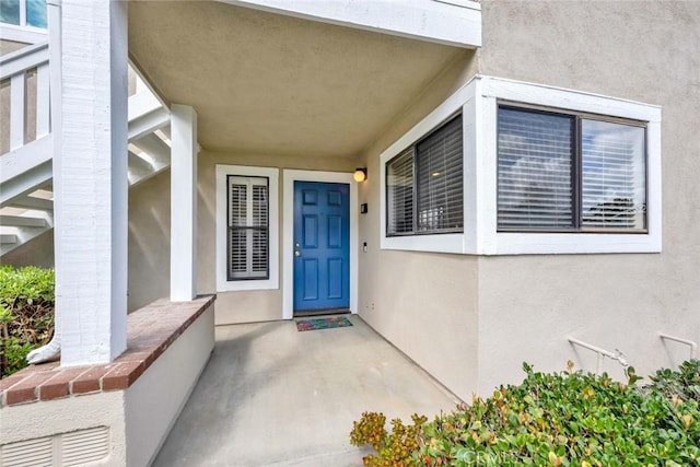 view of exterior entry with stucco siding