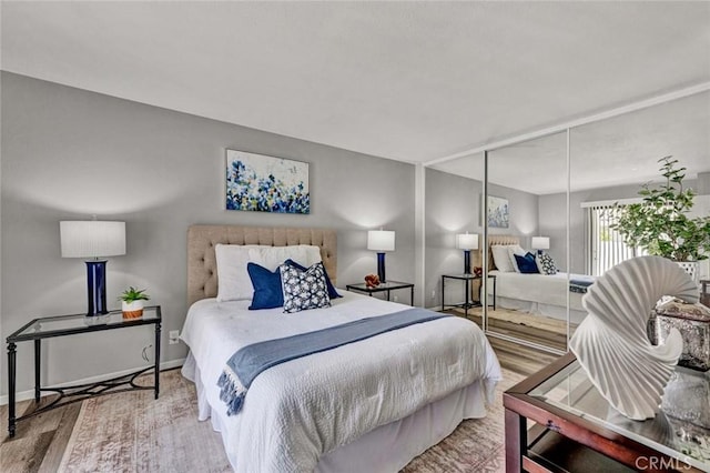 bedroom featuring baseboards and wood finished floors