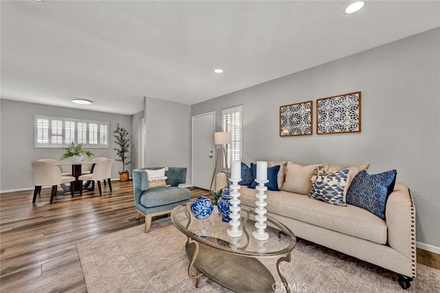 living room featuring recessed lighting, wood finished floors, and baseboards