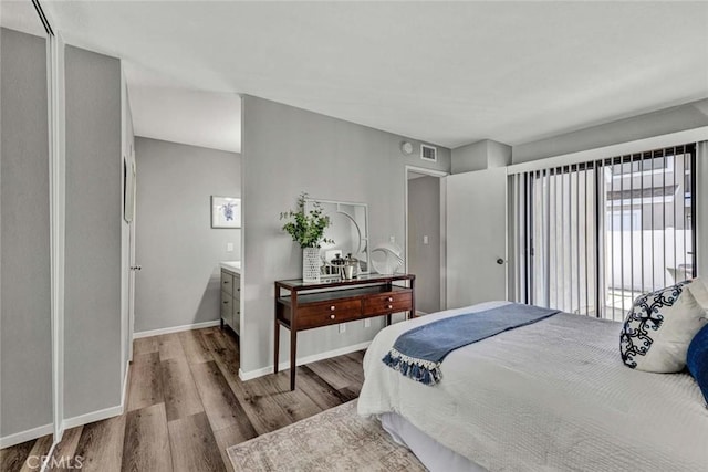 bedroom featuring wood finished floors and baseboards