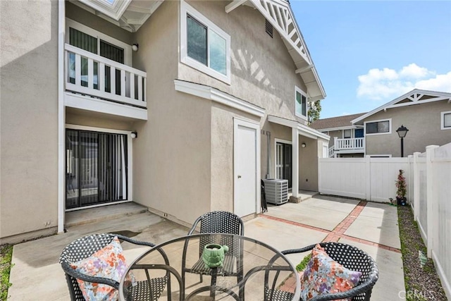 back of house featuring a patio area, a fenced backyard, and stucco siding