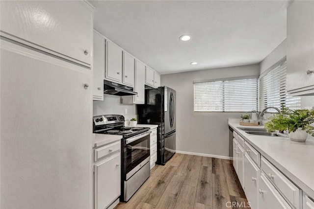 kitchen with light countertops, stainless steel electric range, white cabinets, and under cabinet range hood