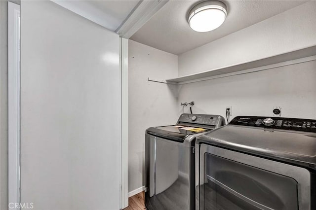 laundry room featuring light wood-type flooring and washer and dryer