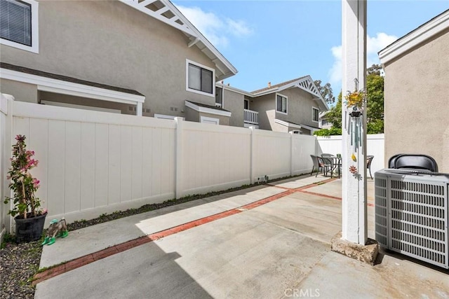 view of patio with a fenced backyard and central AC unit