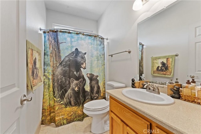 bathroom featuring curtained shower, vanity, toilet, and tile patterned floors