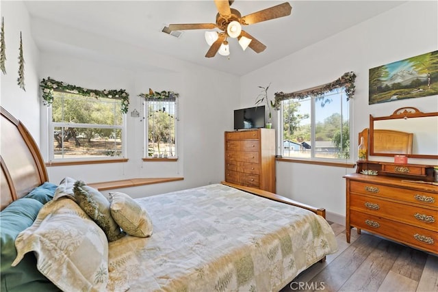 bedroom with ceiling fan and hardwood / wood-style floors