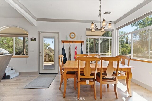 dining space featuring plenty of natural light, visible vents, and an inviting chandelier