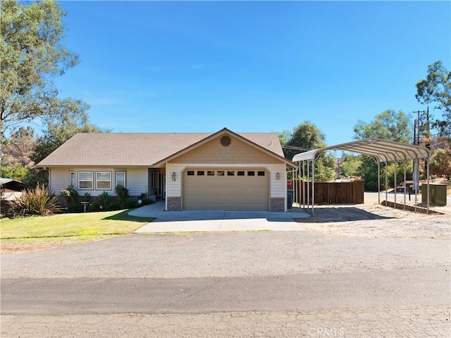 view of front of property featuring a carport, a front yard, driveway, and an attached garage