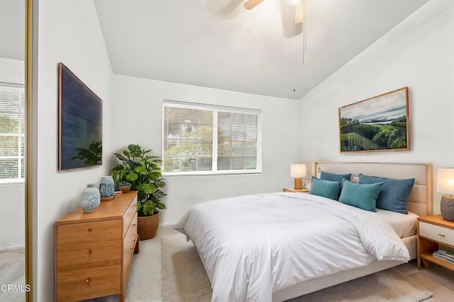 carpeted bedroom featuring a ceiling fan and lofted ceiling