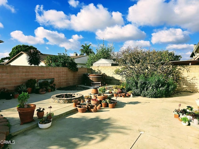 view of patio / terrace with a fire pit and a fenced backyard