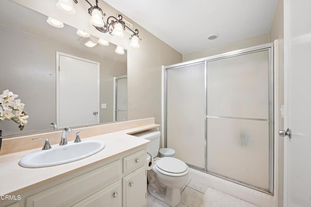 full bathroom with a stall shower, vanity, toilet, and tile patterned floors