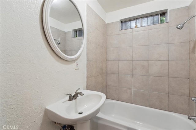 818 Record Ave, East Los Angeles, CA 90063 - full bath with a sink, a textured wall, and shower / washtub combination