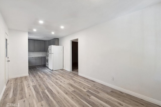 818 Record Ave, East Los Angeles, CA 90063 - unfurnished living room featuring recessed lighting, light wood-style flooring, and baseboards