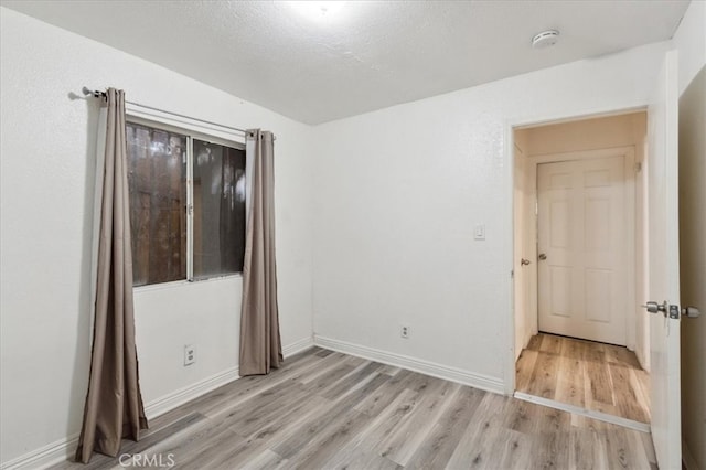818 Record Ave, East Los Angeles, CA 90063 - spare room with light wood-style flooring, a smoke detector, and baseboards