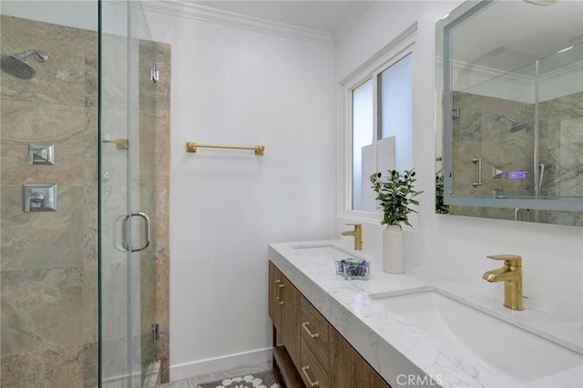 full bath with ornamental molding, a shower stall, baseboards, and a sink