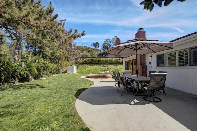 view of patio with a fire pit and outdoor dining area