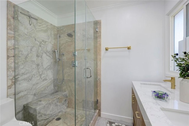 bathroom with baseboards, vanity, a shower stall, and crown molding