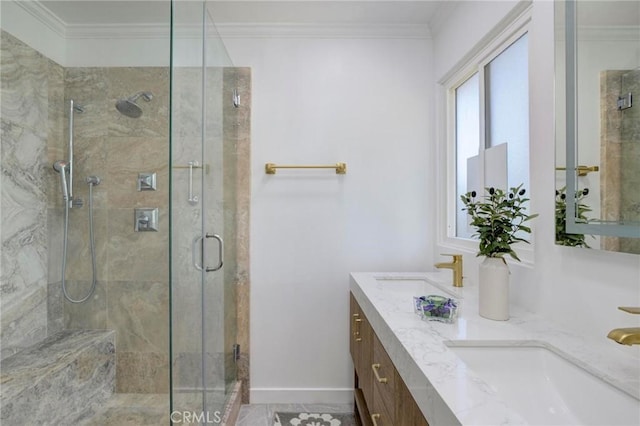 bathroom featuring a sink, a stall shower, and crown molding