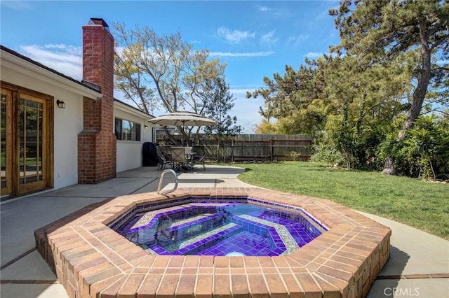 view of swimming pool with a patio, a yard, fence, and an in ground hot tub