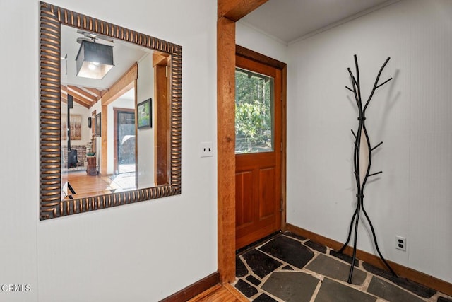 entrance foyer featuring baseboards and ornamental molding